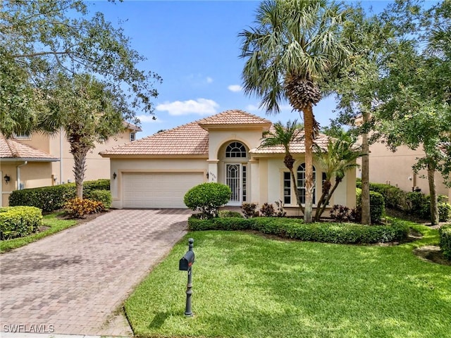 10230 Cobble Hill Rd, Bonita Springs, FL 34135 - mediterranean / spanish home featuring stucco siding, an attached garage, driveway, a front yard, and a tiled roof