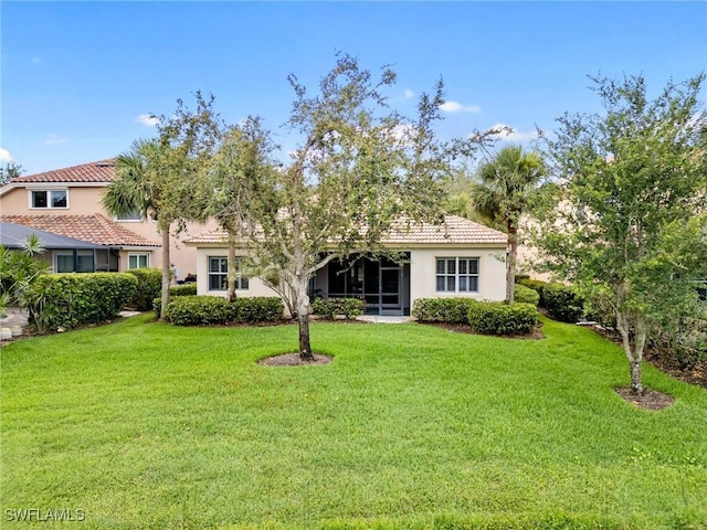 10230 Cobble Hill Rd, Bonita Springs, FL 34135 - back of house featuring stucco siding, a tiled roof, and a yard