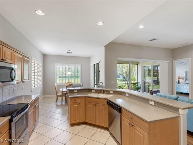 10230 Cobble Hill Rd, Bonita Springs, FL 34135 - kitchen with appliances with stainless steel finishes, a sink, light countertops, light tile patterned flooring, and recessed lighting