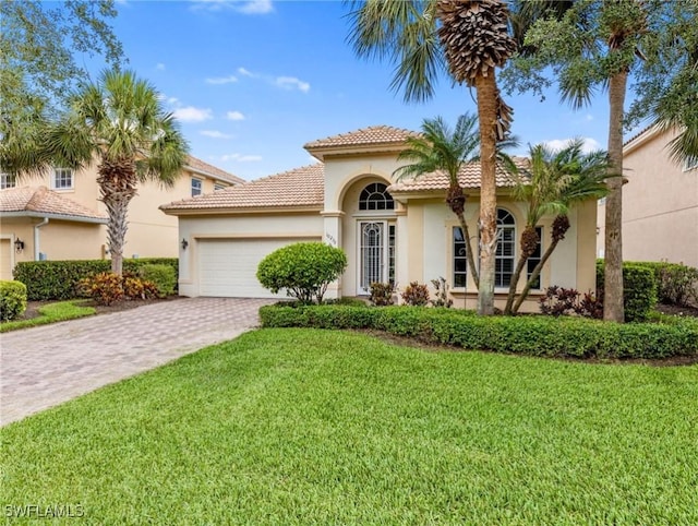 10230 Cobble Hill Rd, Bonita Springs, FL 34135 - mediterranean / spanish-style home featuring stucco siding, decorative driveway, a garage, a front yard, and a tiled roof