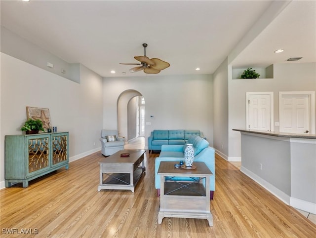 10230 Cobble Hill Rd, Bonita Springs, FL 34135 - living room with arched walkways, baseboards, ceiling fan, light wood-style floors, and recessed lighting
