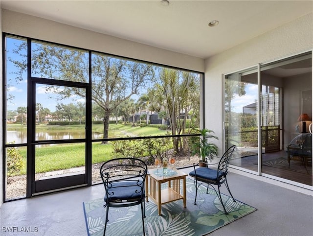 10230 Cobble Hill Rd, Bonita Springs, FL 34135 - sunroom / solarium featuring a water view, healthy amount of natural light, and finished concrete flooring