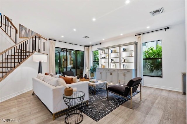 4083 Aspen Chase Dr, Naples, FL 34119 - living area featuring light wood-style floors, recessed lighting, stairway, plenty of natural light, and baseboards