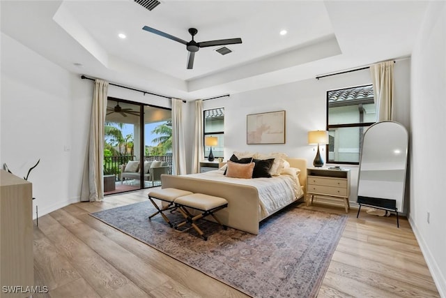 4083 Aspen Chase Dr, Naples, FL 34119 - bedroom featuring a raised ceiling, access to exterior, light wood-type flooring, recessed lighting, and baseboards