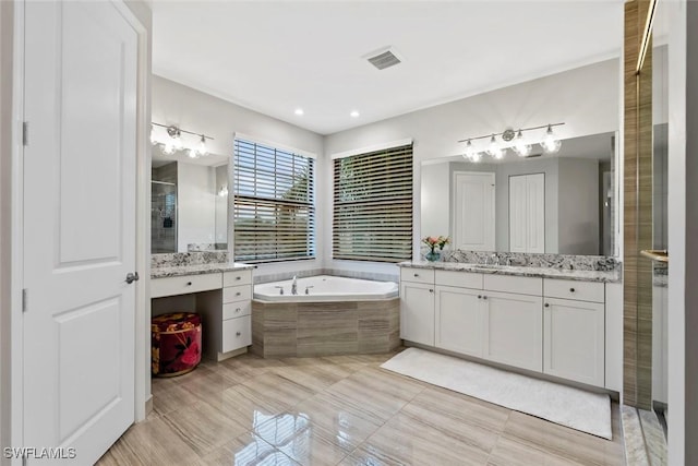 4083 Aspen Chase Dr, Naples, FL 34119 - full bath featuring a garden tub, two vanities, a shower stall, and tile patterned floors