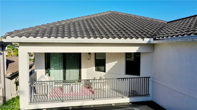 4083 Aspen Chase Dr, Naples, FL 34119 - back of property with stucco siding and a tiled roof