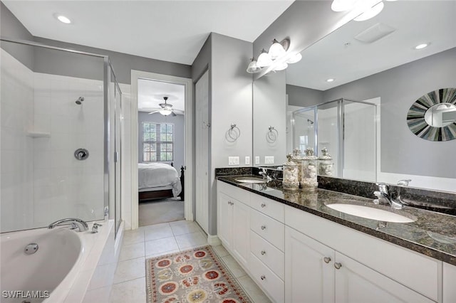 11923 Adoncia Way Unit 2802, Fort Myers, FL 33912 - ensuite bathroom featuring a shower stall, double vanity, tile patterned floors, a garden tub, and ceiling fan