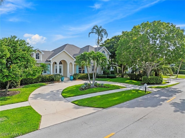 687 9th Ave S, Naples, FL 34102 - view of front facade with curved driveway and a front yard