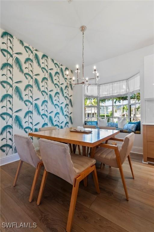 687 9th Ave S, Naples, FL 34102 - dining space with light wood-type flooring, a chandelier, and baseboards
