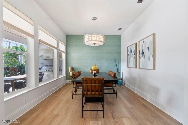 687 9th Ave S, Naples, FL 34102 - dining space featuring an accent wall, wallpapered walls, baseboards, light wood-type flooring, and an office area