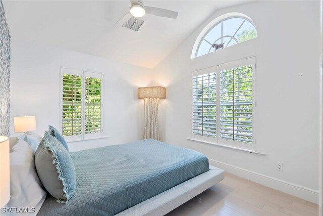 687 9th Ave S, Naples, FL 34102 - bedroom with multiple windows, wood finished floors, vaulted ceiling, a ceiling fan, and baseboards