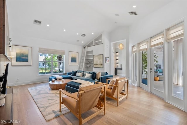 687 9th Ave S, Naples, FL 34102 - living room with high vaulted ceiling, light wood-type flooring, built in features, recessed lighting, and french doors