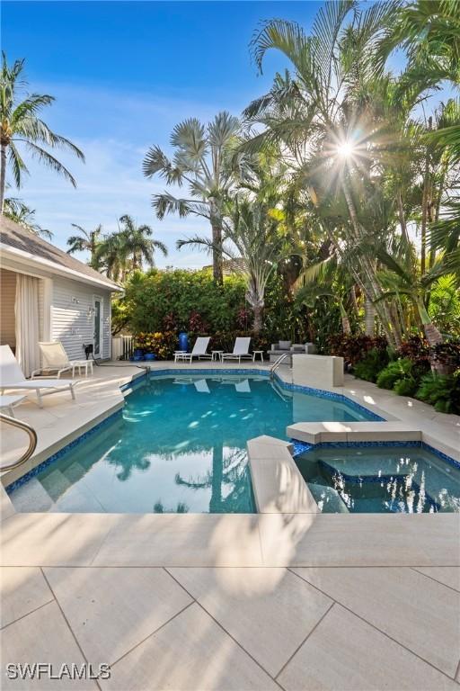 687 9th Ave S, Naples, FL 34102 - outdoor pool with an in-ground hot tub and a patio area