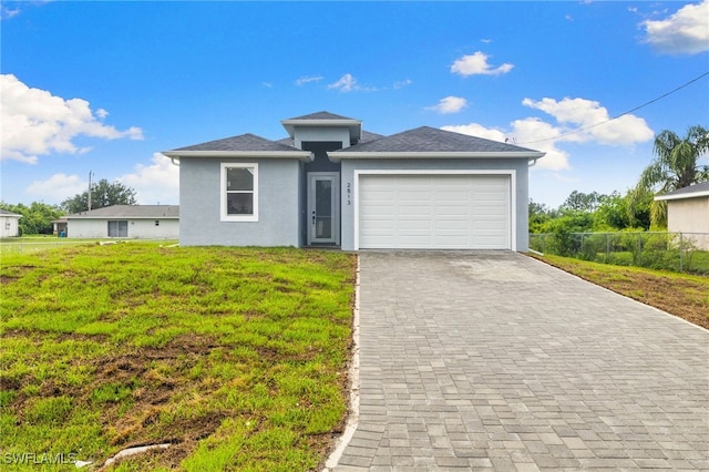 2813 38th St SW, Lehigh Acres, FL 33976 - view of front facade with stucco siding, decorative driveway, and an attached garage