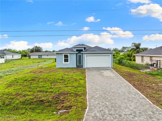 2813 38th St SW, Lehigh Acres, FL 33976 - view of front of house featuring a garage, decorative driveway, and stucco siding