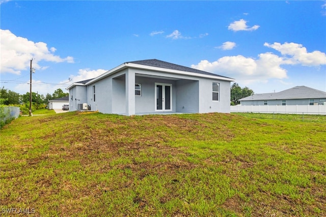 2813 38th St SW, Lehigh Acres, FL 33976 - rear view of house featuring french doors, stucco siding, and cooling unit