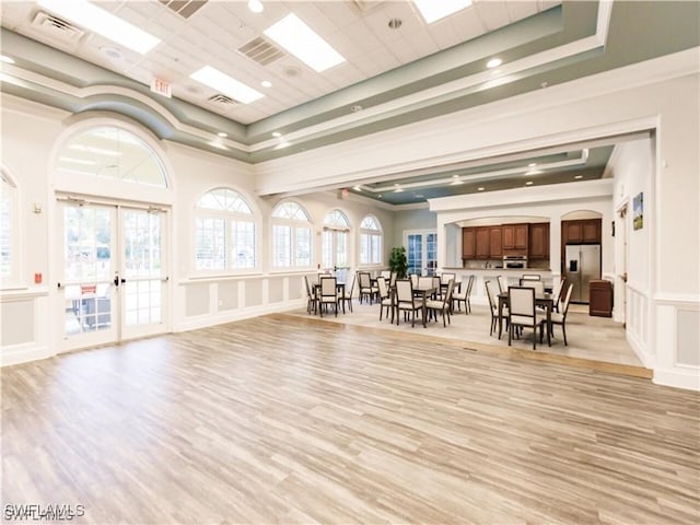 12860 Seaside Key Ct, North Fort Myers, FL 33903 - miscellaneous room with a decorative wall, french doors, light wood-style floors, arched walkways, and recessed lighting
