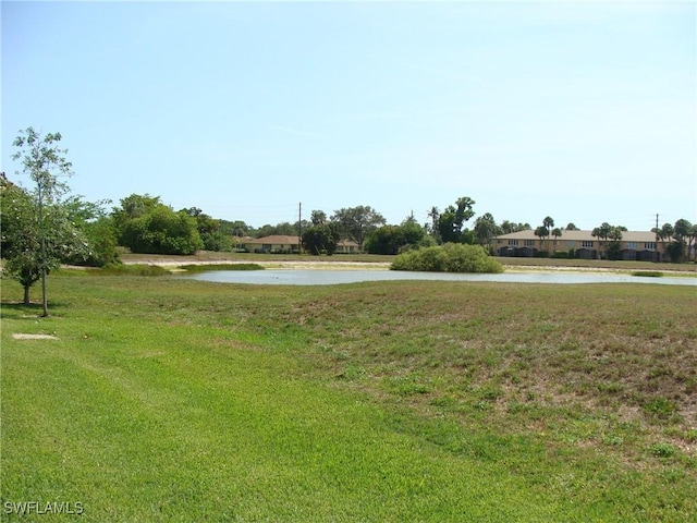 4802 Lakewood Blvd Unit B13, Naples, FL 34112 - view of community with a water view and a yard