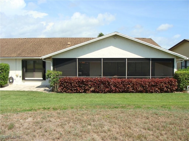 4802 Lakewood Blvd Unit B13, Naples, FL 34112 - rear view of property featuring a yard, a shingled roof, and a sunroom