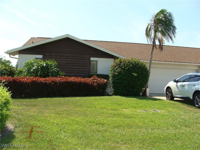 4802 Lakewood Blvd Unit B13, Naples, FL 34112 - view of side of property featuring a lawn and an attached garage
