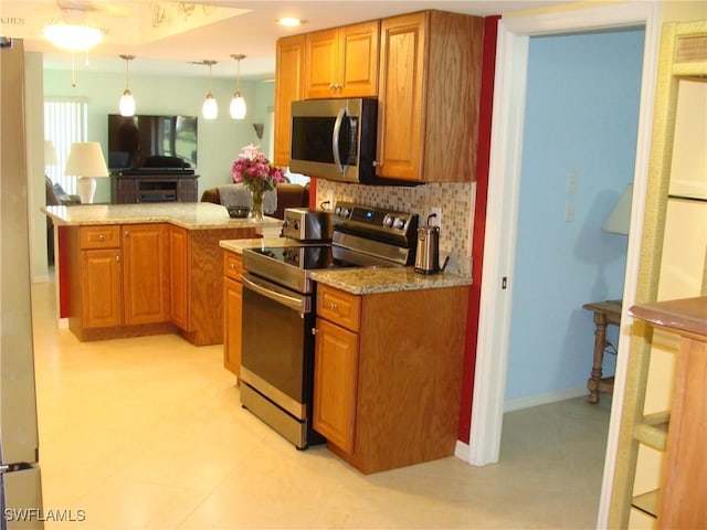 4802 Lakewood Blvd Unit B13, Naples, FL 34112 - kitchen featuring stainless steel appliances, decorative backsplash, a peninsula, decorative light fixtures, and light stone countertops