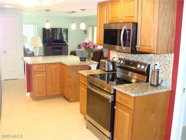 4802 Lakewood Blvd Unit B13, Naples, FL 34112 - kitchen with stainless steel appliances, tasteful backsplash, light stone countertops, and decorative light fixtures