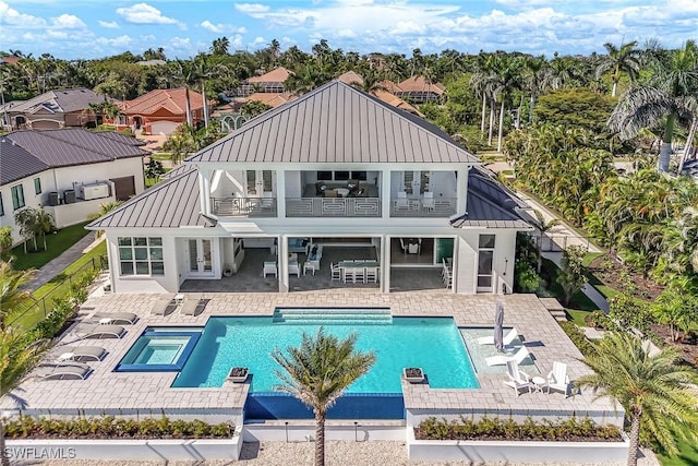 1761 Ludlow Rd, Marco Island, FL 34145 - back of house with a standing seam roof, a balcony, french doors, metal roof, and a patio area