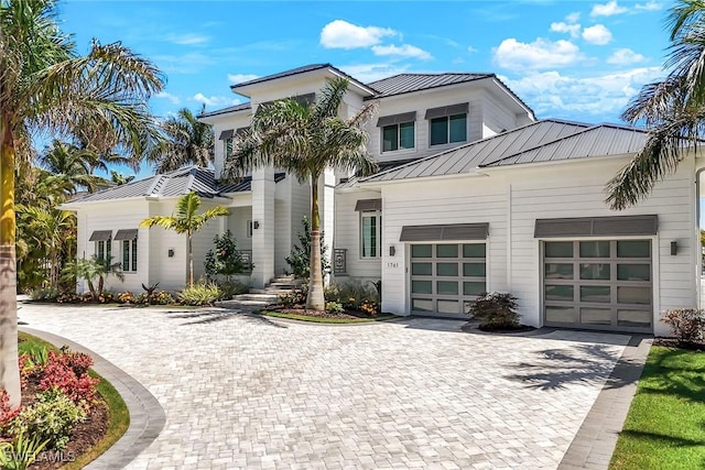 1761 Ludlow Rd, Marco Island, FL 34145 - view of front facade featuring a standing seam roof, decorative driveway, metal roof, and an attached garage