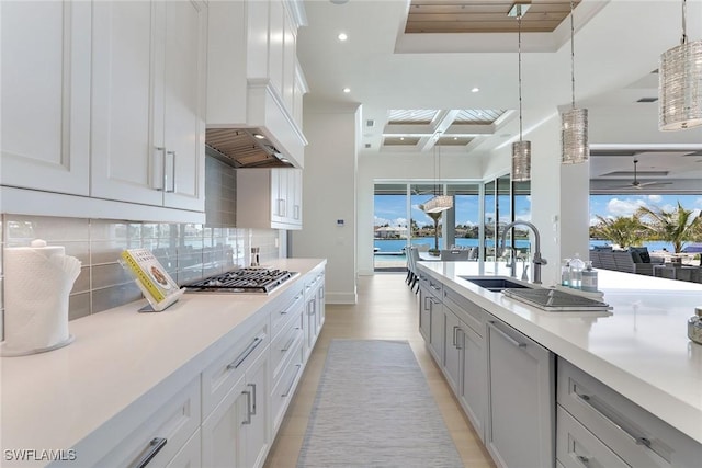1761 Ludlow Rd, Marco Island, FL 34145 - kitchen featuring stainless steel gas stovetop, a sink, tasteful backsplash, coffered ceiling, and light countertops