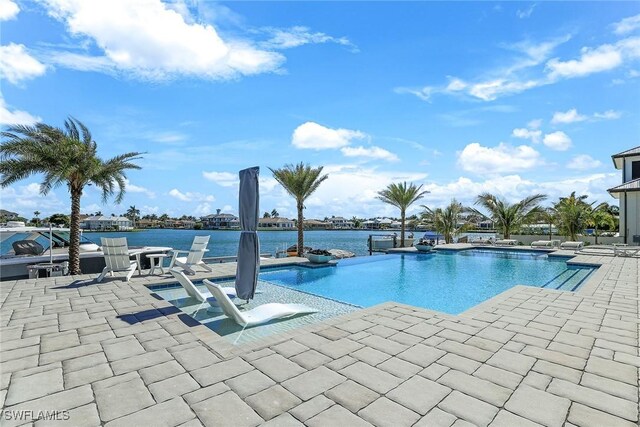 1761 Ludlow Rd, Marco Island, FL 34145 - view of swimming pool with a patio, an infinity pool, and a water view