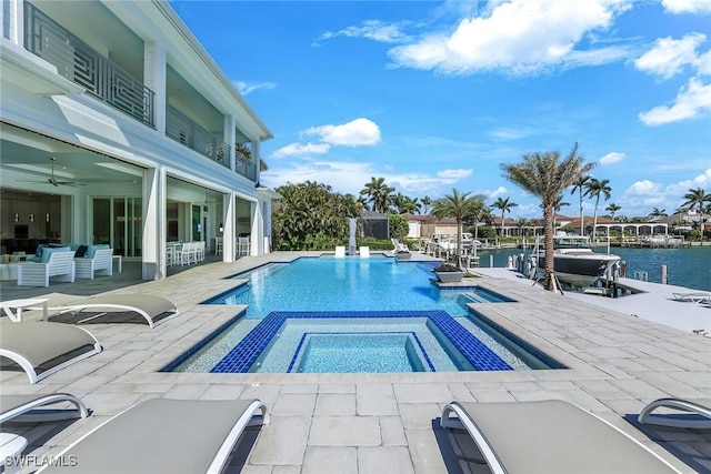 1761 Ludlow Rd, Marco Island, FL 34145 - view of swimming pool with a water view, a patio area, a pool with connected hot tub, and ceiling fan