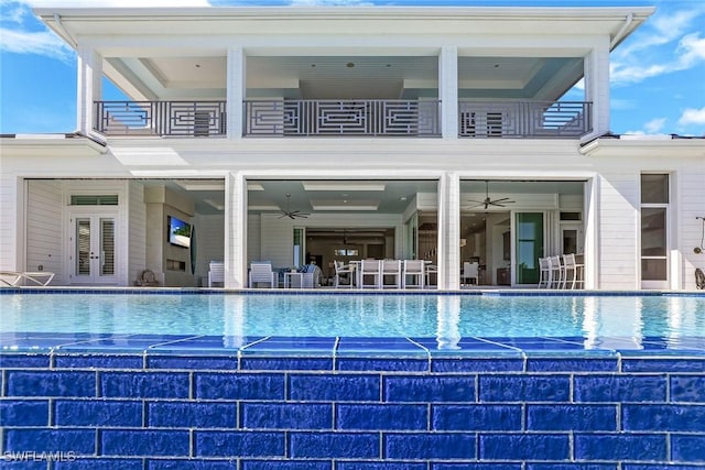 1761 Ludlow Rd, Marco Island, FL 34145 - rear view of house with a balcony, ceiling fan, and an outdoor pool