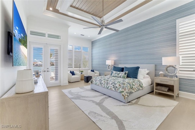 1761 Ludlow Rd, Marco Island, FL 34145 - bedroom with wallpapered walls, an accent wall, access to outside, wood finished floors, and french doors