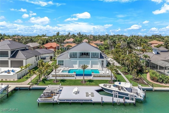 1761 Ludlow Rd, Marco Island, FL 34145 - back of house with an outdoor pool, boat lift, a residential view, a water view, and a patio