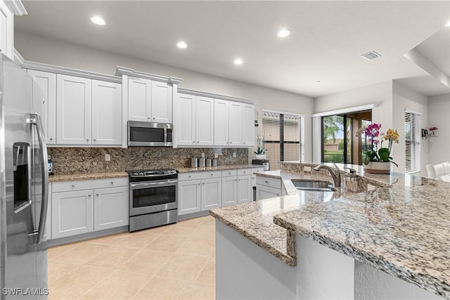 11704 Stonecreek Cir, Fort Myers, FL 33913 - kitchen featuring appliances with stainless steel finishes, a sink, tasteful backsplash, recessed lighting, and light tile patterned floors