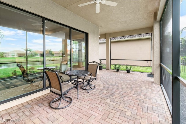 11704 Stonecreek Cir, Fort Myers, FL 33913 - sunroom with a ceiling fan and a water view
