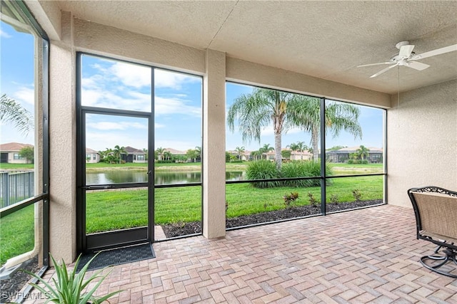 11704 Stonecreek Cir, Fort Myers, FL 33913 - unfurnished sunroom featuring a water view, a ceiling fan, and a residential view