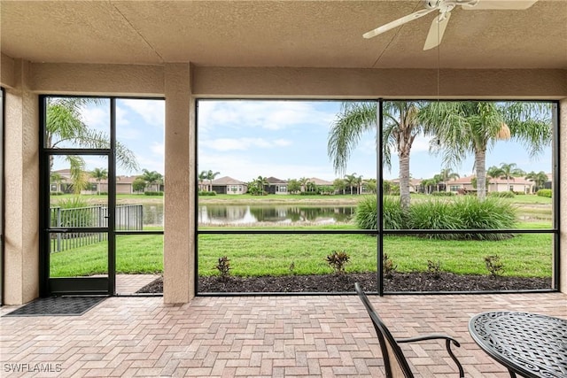 11704 Stonecreek Cir, Fort Myers, FL 33913 - unfurnished sunroom with a water view, a ceiling fan, and a residential view