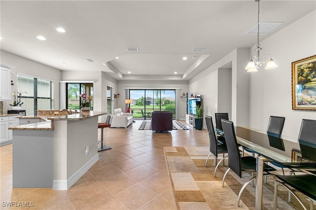 11704 Stonecreek Cir, Fort Myers, FL 33913 - kitchen with white cabinetry, recessed lighting, light tile patterned floors, light stone countertops, and open floor plan
