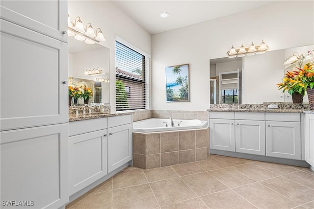 11704 Stonecreek Cir, Fort Myers, FL 33913 - bathroom featuring two vanities, tile patterned floors, and a bath