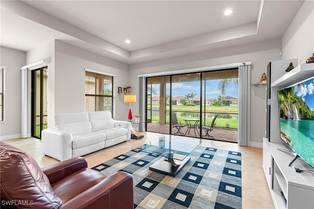 11704 Stonecreek Cir, Fort Myers, FL 33913 - living room featuring light tile patterned floors, a tray ceiling, baseboards, and recessed lighting