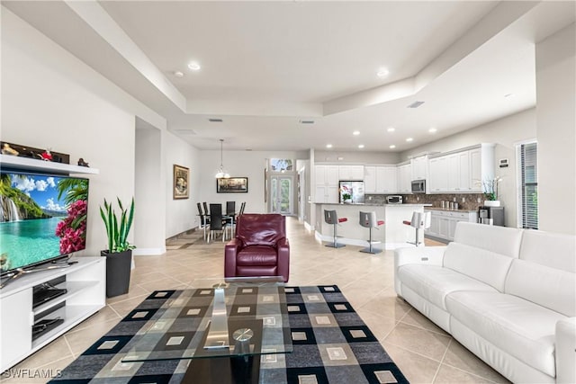 11704 Stonecreek Cir, Fort Myers, FL 33913 - living area featuring light tile patterned flooring, a raised ceiling, recessed lighting, and baseboards