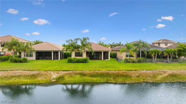 11704 Stonecreek Cir, Fort Myers, FL 33913 - rear view of house with a sunroom, a water view, a tiled roof, and stucco siding