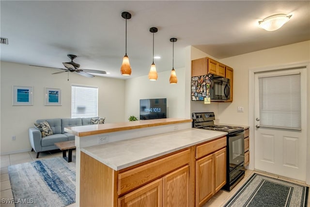 4149 Shellcrest Rd, Saint James City, FL 33956 - kitchen featuring black appliances, open floor plan, a peninsula, and light tile patterned floors