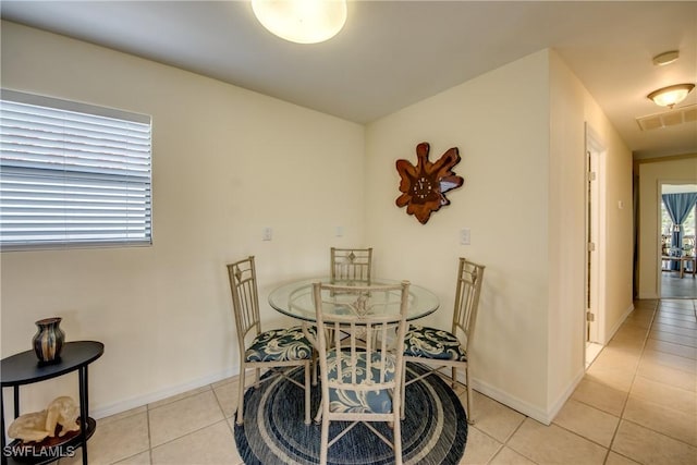4149 Shellcrest Rd, Saint James City, FL 33956 - dining room with light tile patterned floors and baseboards