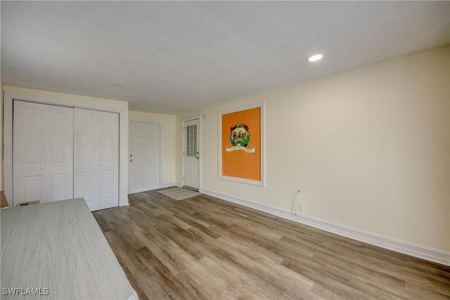 4149 Shellcrest Rd, Saint James City, FL 33956 - unfurnished living room with wood finished floors, baseboards, and recessed lighting