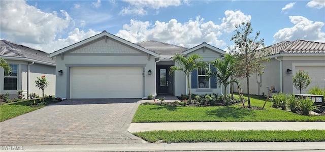 7049 Chapel Creek Ln, North Fort Myers, FL 33917 - ranch-style house with stucco siding, decorative driveway, a garage, a front yard, and a tiled roof
