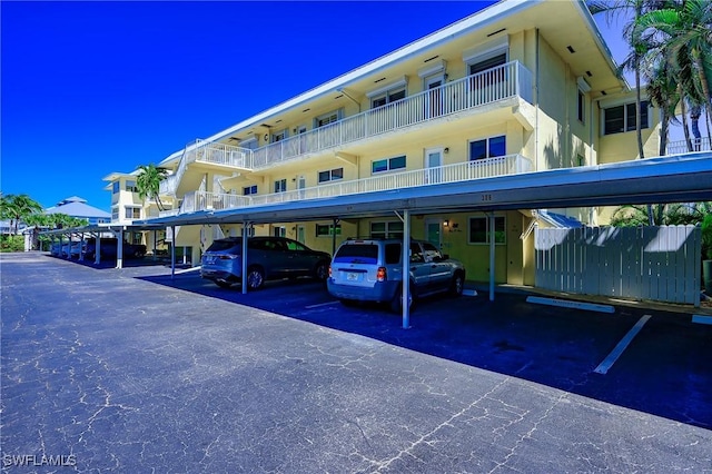 1100 8th Ave S Unit 309C, Naples, FL 34102 - view of building exterior with covered parking