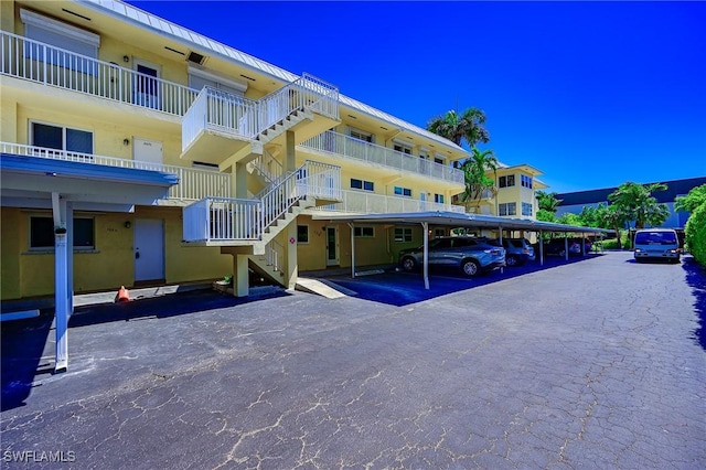 1100 8th Ave S Unit 309C, Naples, FL 34102 - view of apartment building / complex featuring covered parking and stairway