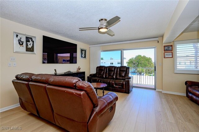 1100 8th Ave S Unit 309C, Naples, FL 34102 - living area with ceiling fan, light wood-style flooring, baseboards, and a textured ceiling